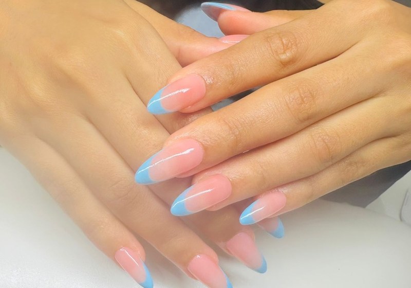 Elegant French tip manicure with gold jewellery at Serene Suite